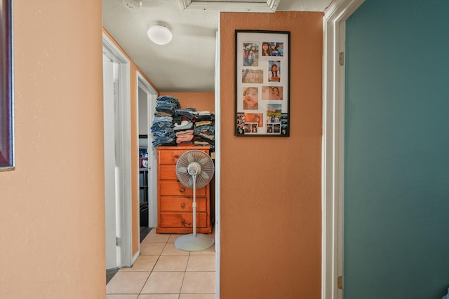 hall featuring light tile patterned floors