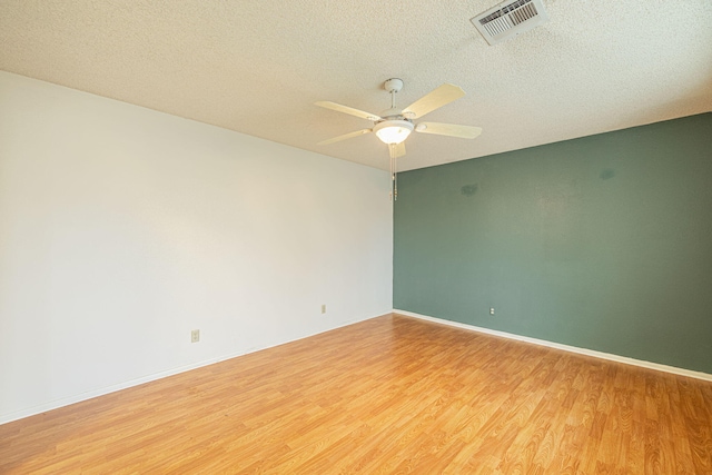 unfurnished room featuring ceiling fan, a textured ceiling, and light wood-type flooring