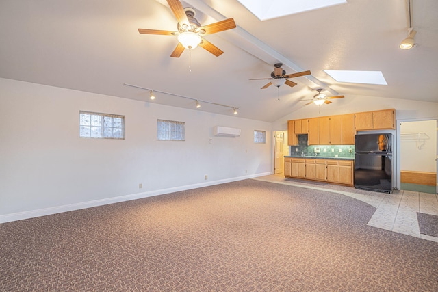 unfurnished living room featuring ceiling fan, light colored carpet, vaulted ceiling with skylight, and an AC wall unit