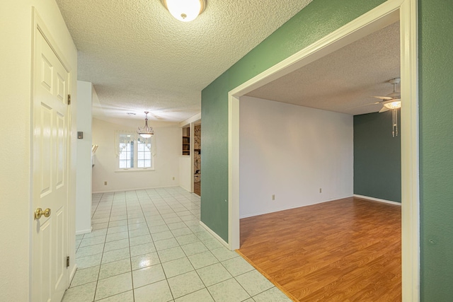 interior space featuring light tile patterned floors and a textured ceiling