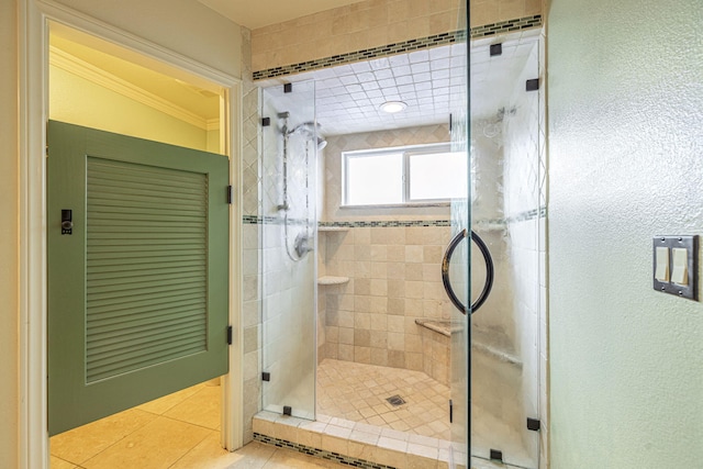 bathroom featuring tile patterned flooring, crown molding, and an enclosed shower