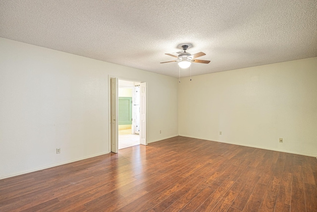 spare room with ceiling fan, dark hardwood / wood-style flooring, and a textured ceiling