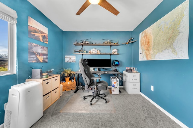 office featuring carpet floors, plenty of natural light, baseboards, and ceiling fan