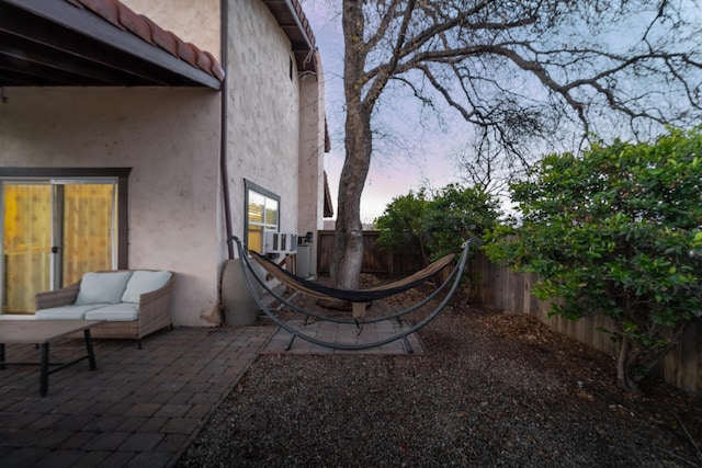 yard at dusk with fence and a patio