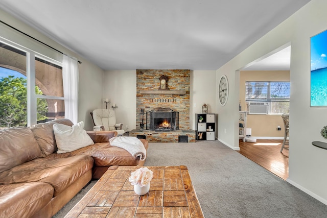 carpeted living room featuring cooling unit, a fireplace, and baseboards