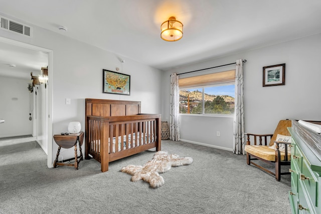 carpeted bedroom with a nursery area, baseboards, and visible vents