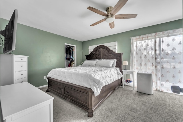 bedroom with baseboards, a ceiling fan, carpet, a spacious closet, and a closet