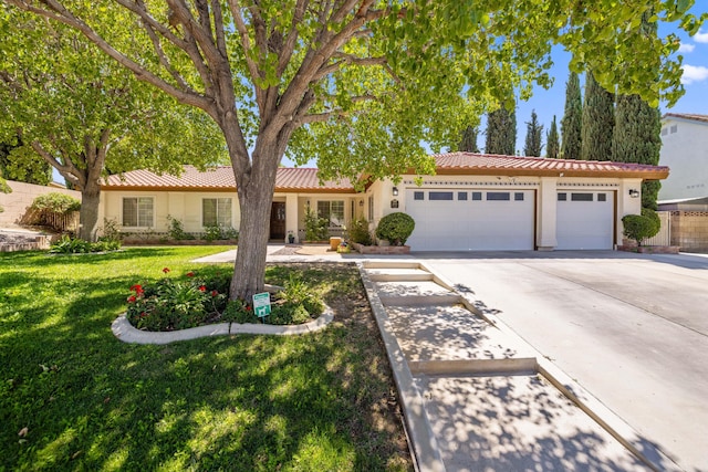 single story home featuring a front yard and a garage