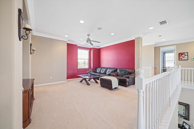 carpeted living room featuring crown molding and ceiling fan