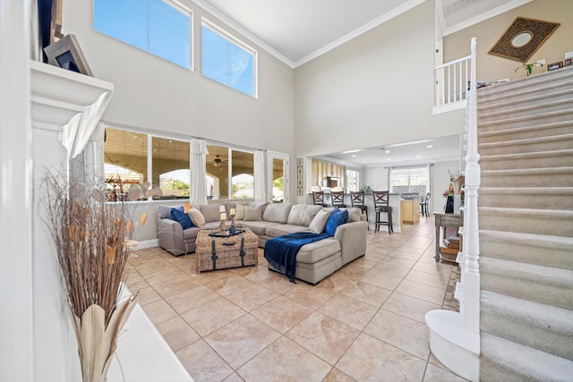 tiled living room with a towering ceiling and ornamental molding