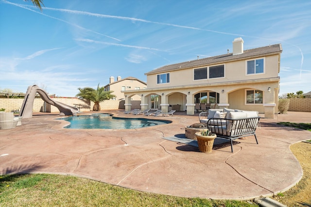 view of swimming pool with an outdoor living space with a fire pit, a patio, and a water slide