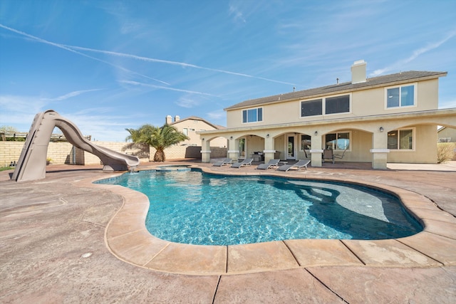 view of pool with a patio and a water slide