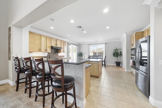 kitchen with a kitchen bar, ornamental molding, light tile patterned floors, kitchen peninsula, and stainless steel appliances