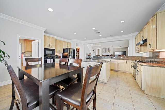 kitchen with light tile patterned flooring, light brown cabinets, ornamental molding, kitchen peninsula, and black appliances