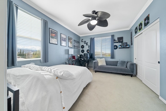 carpeted bedroom with ornamental molding, a closet, and ceiling fan