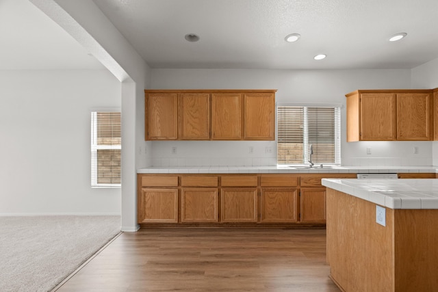 4349 Bethpage Dr, Palmdale, CA 93551 - kitchen featuring a sink, tile counters, light wood-style floors, brown cabinets, and recessed lighting