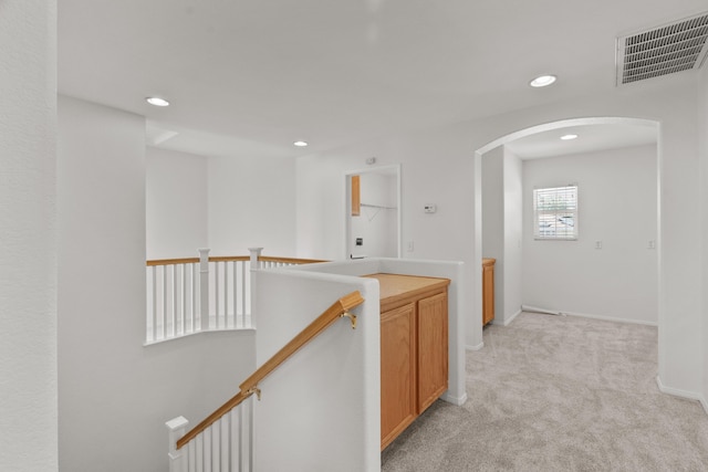 4349 Bethpage Dr, Palmdale, CA 93551 - corridor with an upstairs landing, arched walkways, light colored carpet, recessed lighting, and baseboards