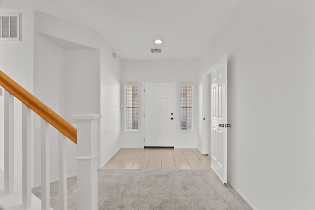 4349 Bethpage Dr, Palmdale, CA 93551 - carpeted foyer entrance with tile patterned floors, stairway, and baseboards
