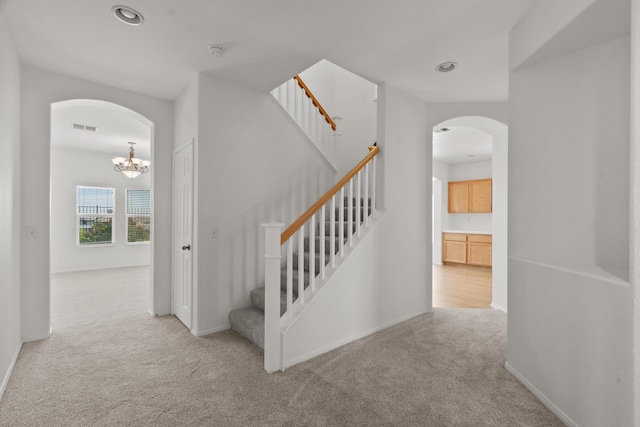 4349 Bethpage Dr, Palmdale, CA 93551 - stairs featuring arched walkways, carpet floors, a chandelier, recessed lighting, and baseboards
