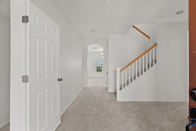 4349 Bethpage Dr, Palmdale, CA 93551 - entrance foyer with carpet floors, arched walkways, baseboards, and stairway