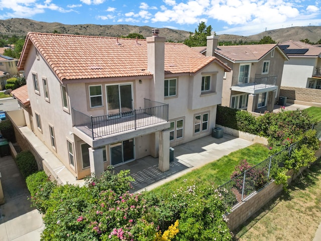 4349 Bethpage Dr, Palmdale, CA 93551 - rear view of house featuring a balcony, stucco siding, and a mountain view
