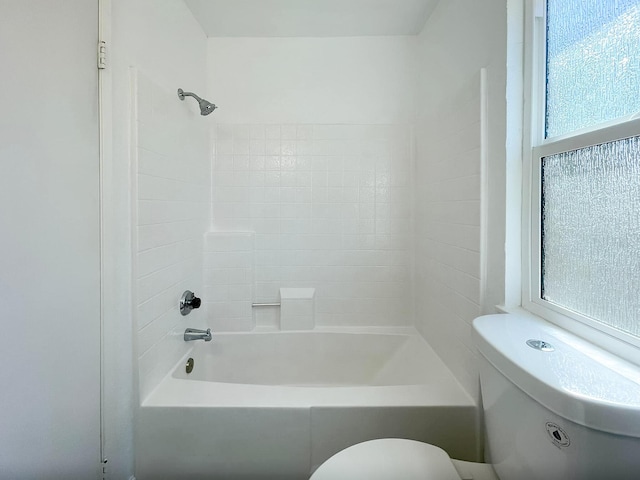 bathroom featuring bathtub / shower combination and toilet