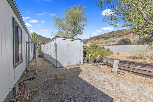 view of yard with a mountain view and a shed