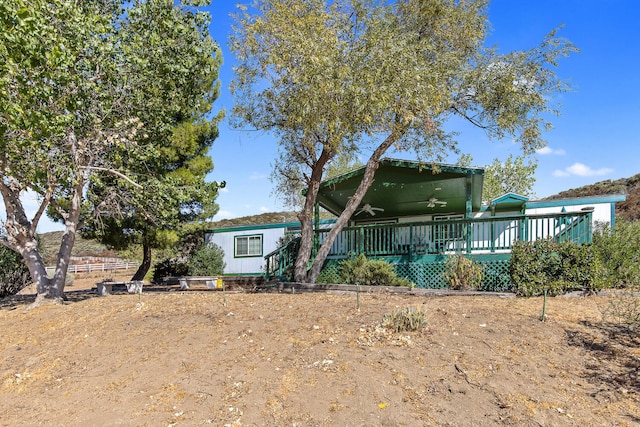 back of property with a wooden deck