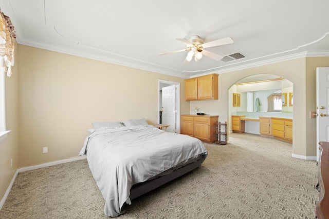 bedroom featuring light colored carpet, crown molding, and baseboards