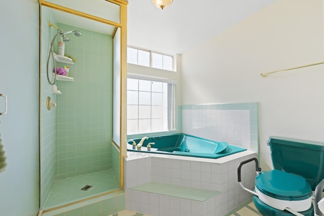 full bathroom featuring a stall shower and a garden tub