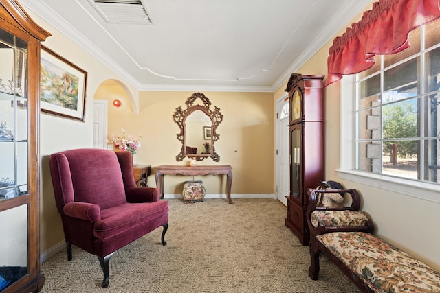 living area featuring arched walkways, carpet flooring, visible vents, baseboards, and crown molding