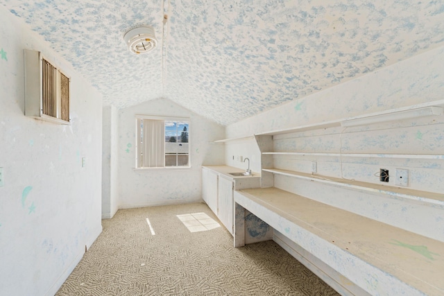 bonus room with lofted ceiling, light carpet, a sink, and wallpapered walls