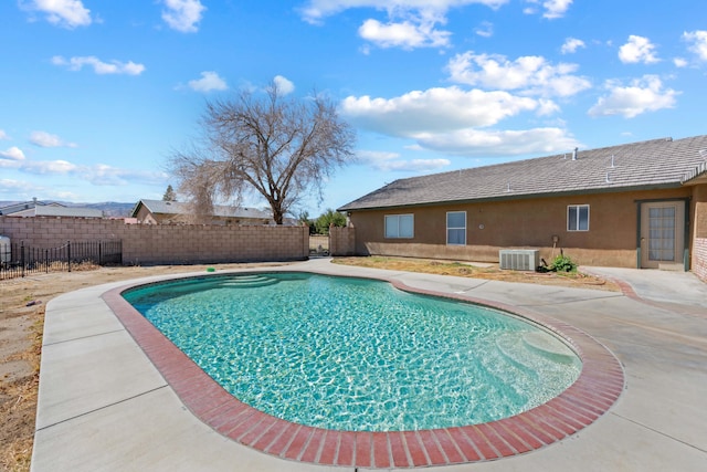 view of pool featuring a patio, central AC, fence, and a fenced in pool