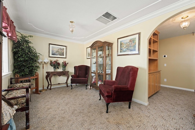 living area featuring light carpet, baseboards, visible vents, arched walkways, and crown molding