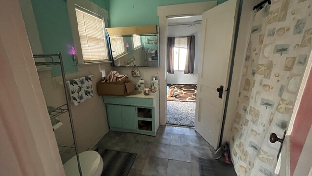 bathroom with a shower, vanity, and toilet