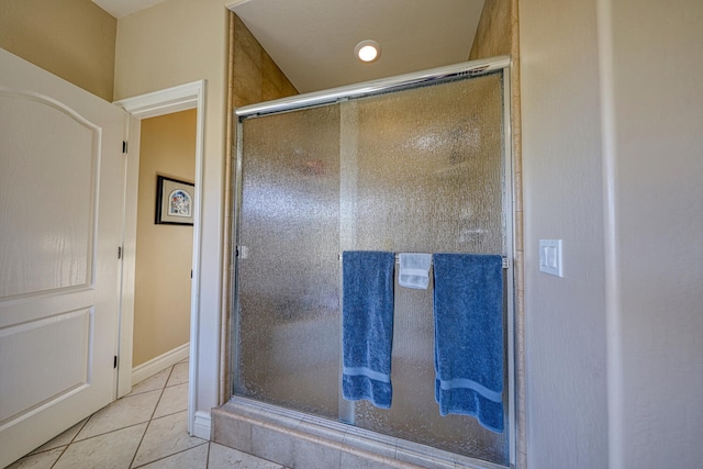 bathroom with tile patterned flooring and an enclosed shower