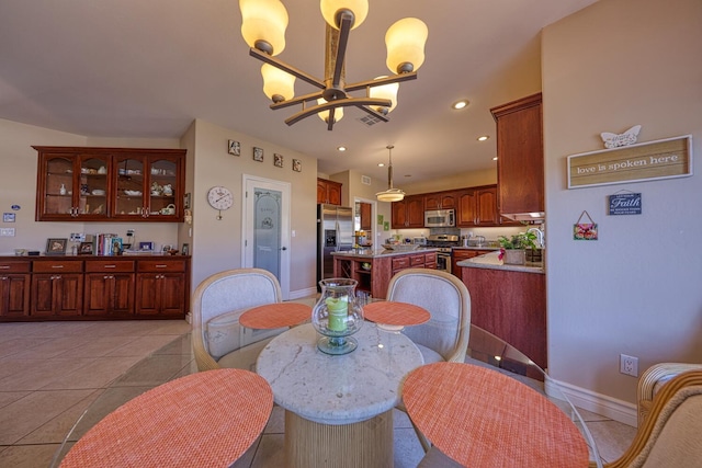 dining area featuring light tile patterned flooring and a notable chandelier