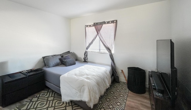 bedroom with wood finished floors