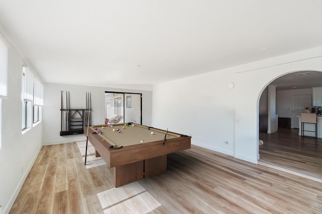 recreation room with light wood-style floors, arched walkways, pool table, and baseboards