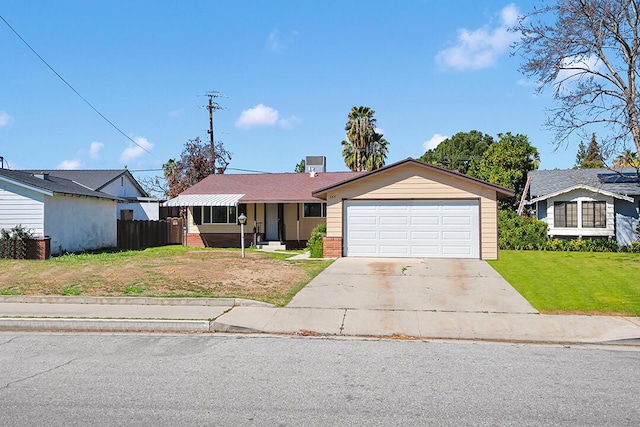 single story home with brick siding, fence, concrete driveway, a front yard, and a garage