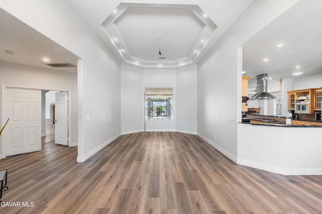 42094 W 21st St, Lancaster, CA 93536 - unfurnished living room with wood finished floors, recessed lighting, and a tray ceiling