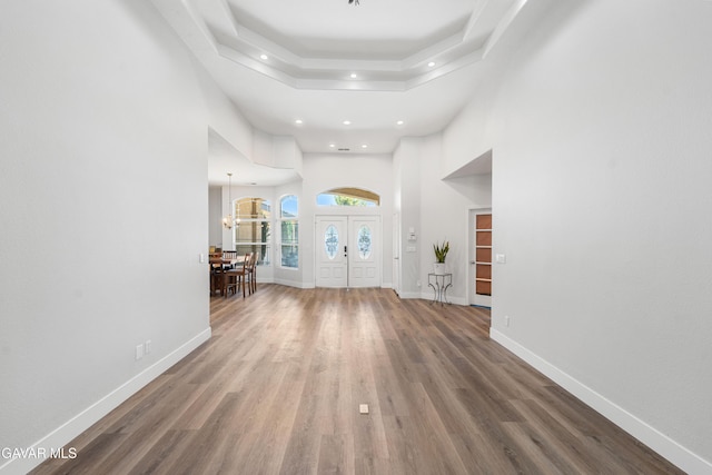 42094 W 21st St, Lancaster, CA 93536 - entryway with recessed lighting, wood finished floors, a towering ceiling, a tray ceiling, and a chandelier