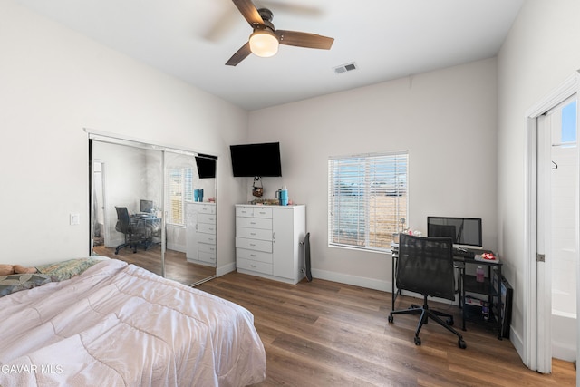 42094 W 21st St, Lancaster, CA 93536 - bedroom with a desk, multiple windows, and wood finished floors
