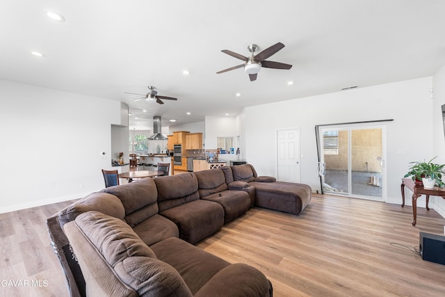 42094 W 21st St, Lancaster, CA 93536 - living room featuring a ceiling fan, healthy amount of natural light, light wood-style floors, and recessed lighting