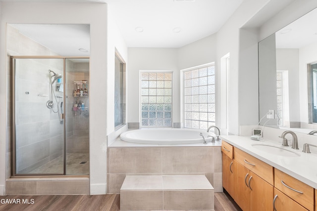 42094 W 21st St, Lancaster, CA 93536 - bathroom featuring vanity, a bath, a shower stall, wood finished floors, and recessed lighting