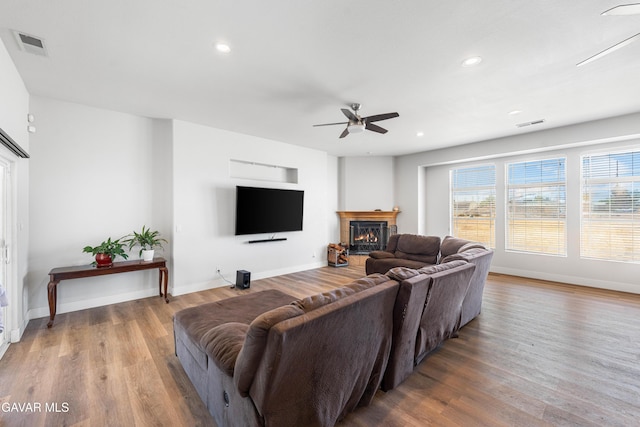42094 W 21st St, Lancaster, CA 93536 - living area featuring a ceiling fan, wood finished floors, a warm lit fireplace, and recessed lighting