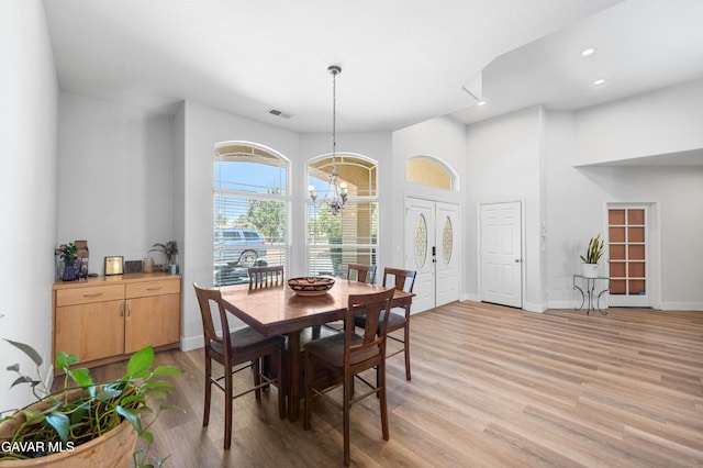 42094 W 21st St, Lancaster, CA 93536 - dining room featuring a chandelier, light wood-type flooring, recessed lighting, and a high ceiling