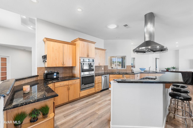 42094 W 21st St, Lancaster, CA 93536 - kitchen with a peninsula, stainless steel appliances, light wood-type flooring, ventilation hood, and light brown cabinetry