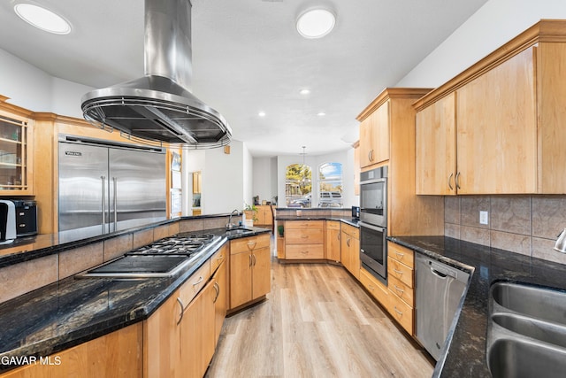 42094 W 21st St, Lancaster, CA 93536 - kitchen with stainless steel appliances, light wood-style flooring, range hood, light brown cabinets, and tasteful backsplash