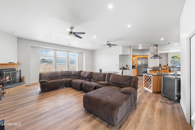 42094 W 21st St, Lancaster, CA 93536 - living area featuring light wood-style floors, recessed lighting, ceiling fan, and a tile fireplace